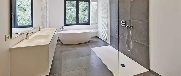 Modern bathroom with frameless glass shower and freestanding bathtub in Central Florida remodel
